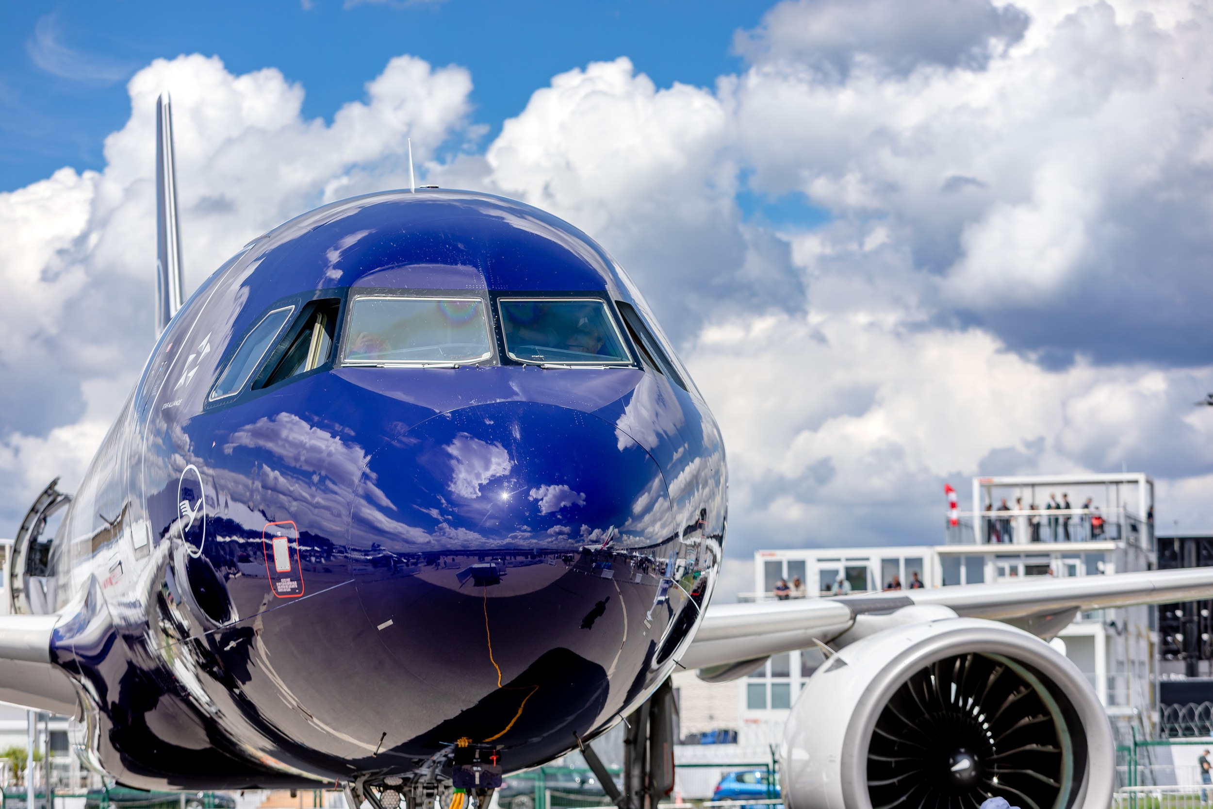 The dark blue nose of a Lufthansa Airbus A320neo fills this frontal view in the static display at ILA Berlin 2026. Its c